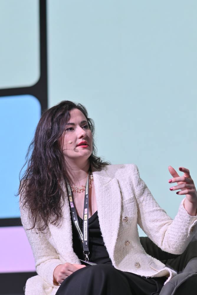 Milica Krstić speaking on stage
